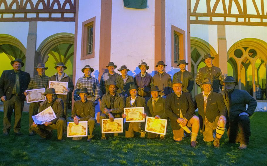 Eighteen Americans, newly-inducted into the German hunting community, pose for a photo following a Jaegerschlag, a German hunting initiation ceremony, at Eberbach Abbey near Eltville, Sunday, Oct. 30, 2016.