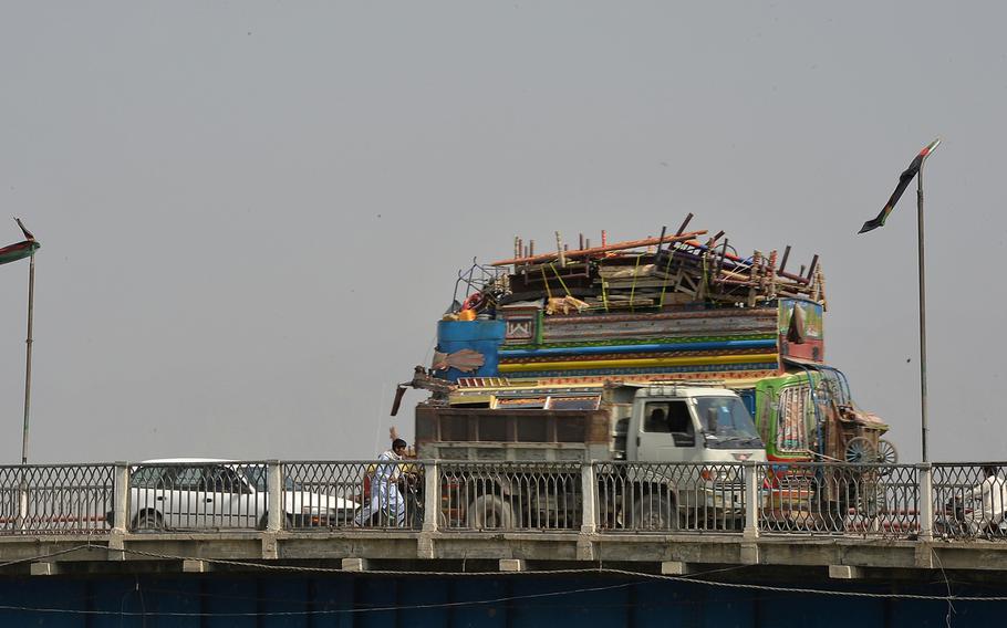 A truck laden with belongings of refugees repatriated to Afghanistan from Pakistan, crosses a bridge over the Kabul River in Jalalabad, Afghanistan, on Wednesday, Oct. 5, 2016. Nearly 370,000 refugees have returned from Pakistan so far this year.