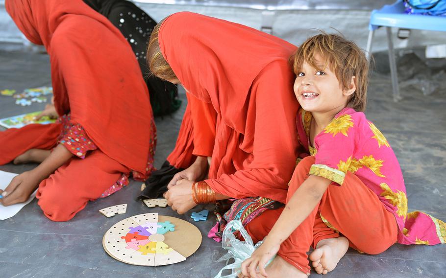 Afghan girls from families returning to Afghanistan after years of seeking refuge in Pakistan, play games in a UNICEF-sponsored tent at the Samarkhel Encashment Center near Jalalabad, Afghanistan, on Thursday, Oct. 6, 2016.