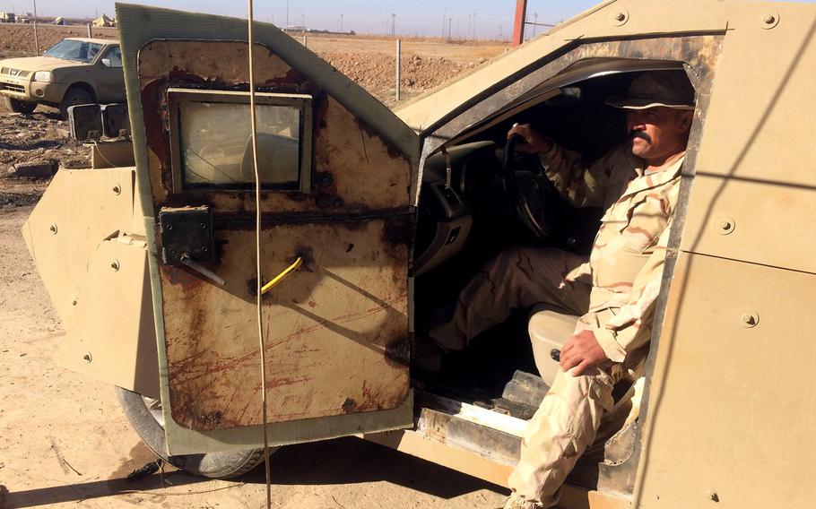 An Iraqi soldier sits inside an abandoned Islamic State SUV covered with bolt-on armored plates, on Wednesday, Nov. 2, 2016. The bizarre vehicle is an example of the homemade weapons that fleeing Islamic State militants left on the battlefield at the village of Kermlis, near Mosul.