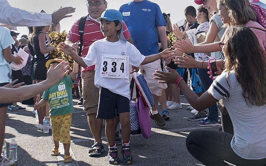 Athletes parade through a colossal crowd of supporters prior to participating the 2016 Kadena Special Olympics.