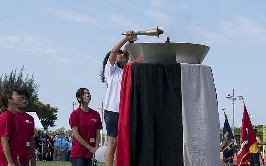 The Olympic flame is lit, signifying the beginning of the 2016 Kadena Special Olympics.