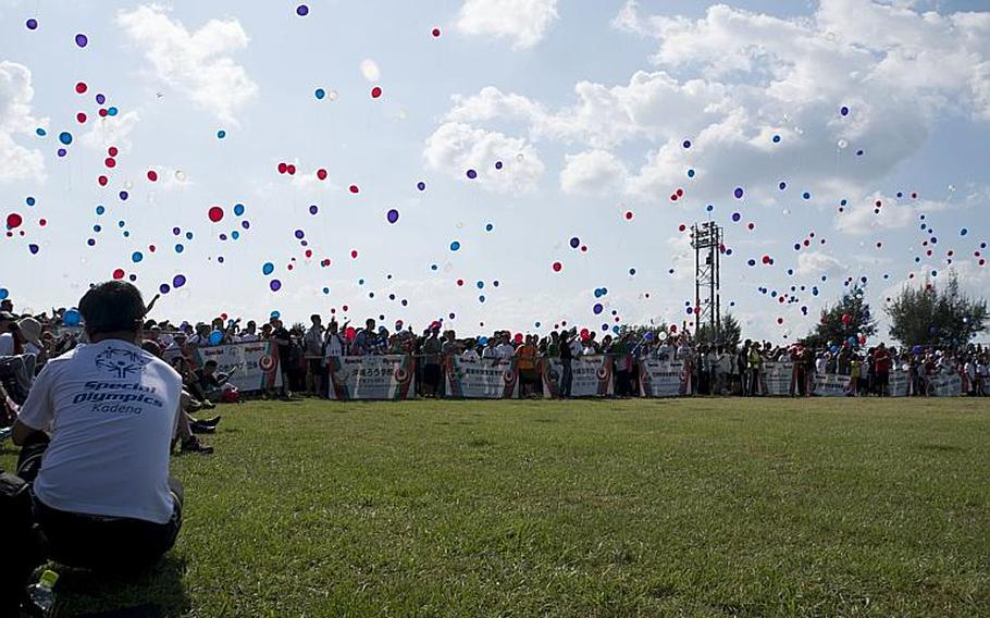 Thousands and athletes and supporters release balloons at the start of the 2016 Kadena Special Olympics.