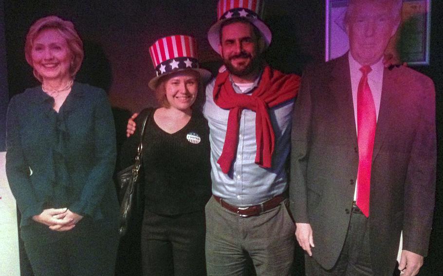 Alaina and Kyle Missbach of the U.S. consulate in Frankfurt, Germany, pose with cutouts of the two presidential candidates at Gibson Club in downtown Frankfurt during an election-night party, Tuesday, Nov. 8, 2016. Hundreds of Germans and Americans gathered at the club to watch election results come in live overnight.