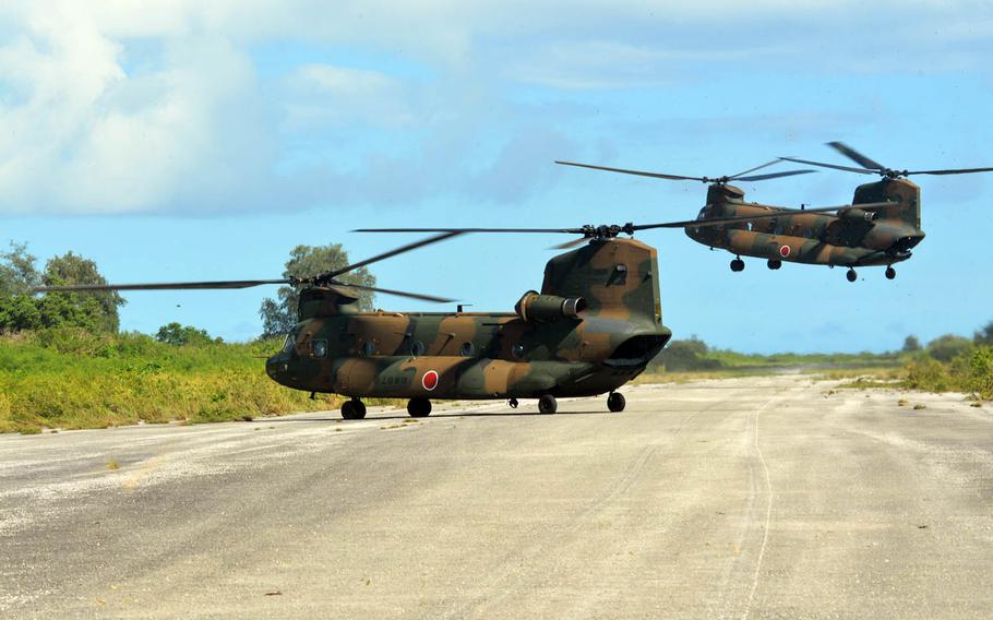 Japan Self-Defense Forces helicopters land on a World War II-era runway on Tinian, in the Northern Marianas, Tuesday, Nov. 8, 2016. U.S. forces assisted the Japanese-led event as part of the bilateral Keen Sword exercise.