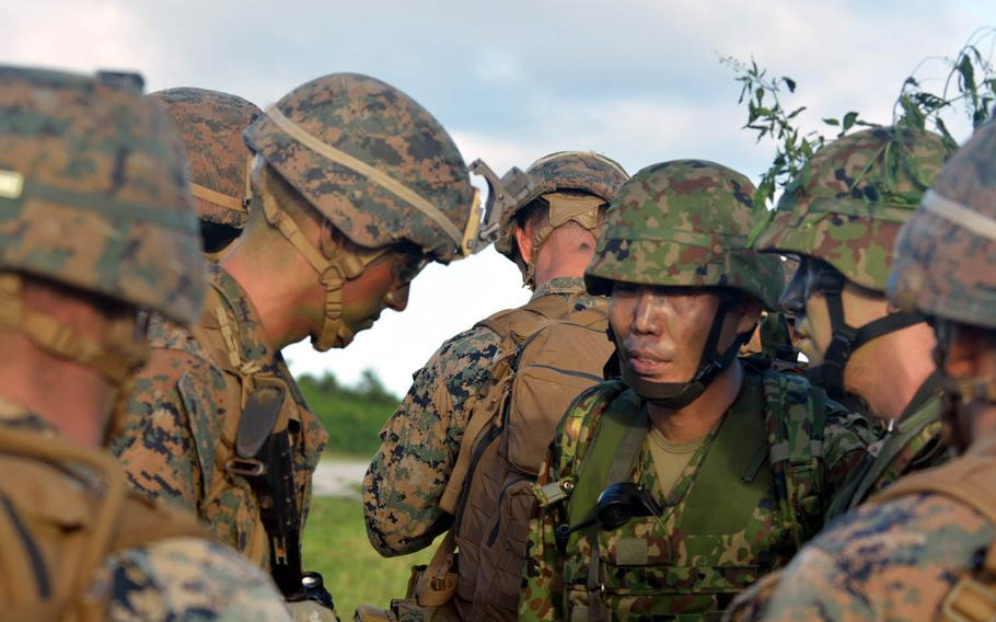 Marines discuss tactics with Japan Self-Defense Forces troops during a scenario to retake a captured island on Tinian, in the Northern Marianas, Tuesday, Nov.8, 2016. The scenario came as part of the bilateral Keen Sword exercise.