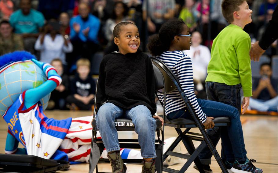 Children from the audience play musical chairs with Globie, the Harlem Globetrotters mascot, during a show at Ramstein Air Base, Germany, on Thursday, Nov. 10, 2016