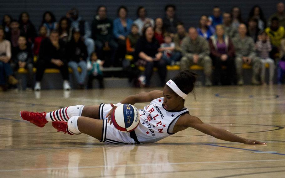 TNT Lister, a Harlem Globetrotter, slides across the floor during a show at Ramstein Air Base, Germany, on Thursday, Nov. 10, 2016