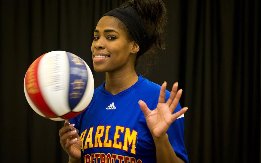 Harlem Globetrotter TNT Lister spins the ball on her finger during an interview at Ramstein Air Base, Germany, on Thursday, Nov. 10, 2016.