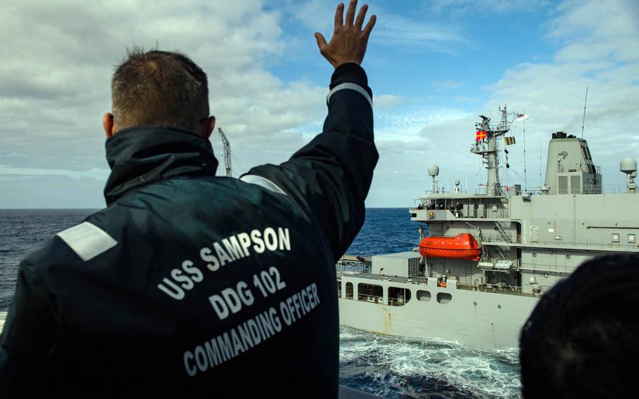 Cmdr. Timothy Labenz of the guided-missile destroyer USS Sampson hails New Zealand's HMS Endeavour before a replenishment at sea in the Pacific Ocean, Sunday, Nov. 13, 2016.