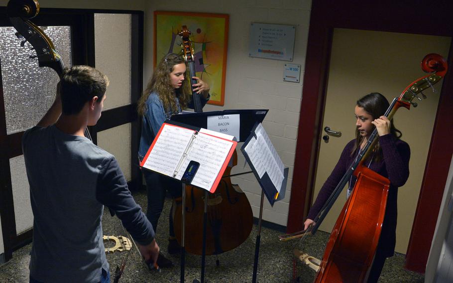 From left bassists Andrew Taylor from Sigonella, Maria Bacon from Vilseck  and Graciela Vazquez from Vicenza rehearse in a hallway during sectionals at Creative Connections, Tuesday, Nov. 15, 2016.
