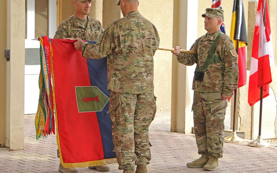 Maj. Gen. Joseph Martin, commanding general of 1st Infantry Division and the division's senior enlisted soldier, Command Sgt. Maj. Curt Cornelison, uncase the 'Big Red One' colors during the transfer of authority ceremony, Nov. 17, 2016, in Baghdad, Iraq. This is the second tour for the division in support of Operation Inherent Resolve.