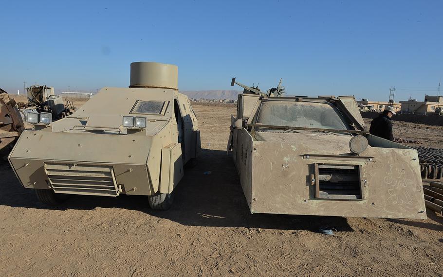 Two armored trucks seized from Islamic State fighters near Mosul are pictured here on display outside an Iraqi army camp in Karamlis on Saturday, Nov. 19, 2016.