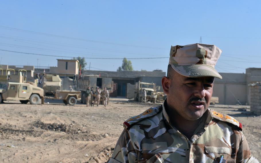 Iraqi army Col. Walid Dakhal speaks to reporters in the village of Scheherazade outside Mosul on Saturday, Nov. 19, 2016. Dakhal's troops are pushing forward in Mosul as part of an effort to clear the area of Islamic State fighters who have controlled Iraq's second largest city since 2014.