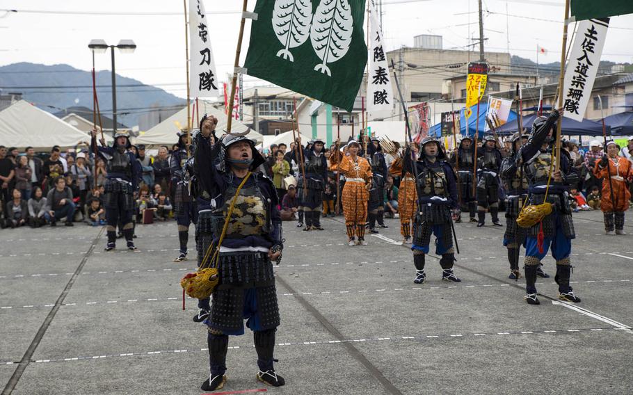 Samurai warriors yell out in encouragement during the 27th-annual Kuragake Festival and Samurai March in Iwakuni City, Japan, Sunday, Nov. 20, 2016. Marines from Marine Corps Air Station Iwakuni were invited to join in the parade.