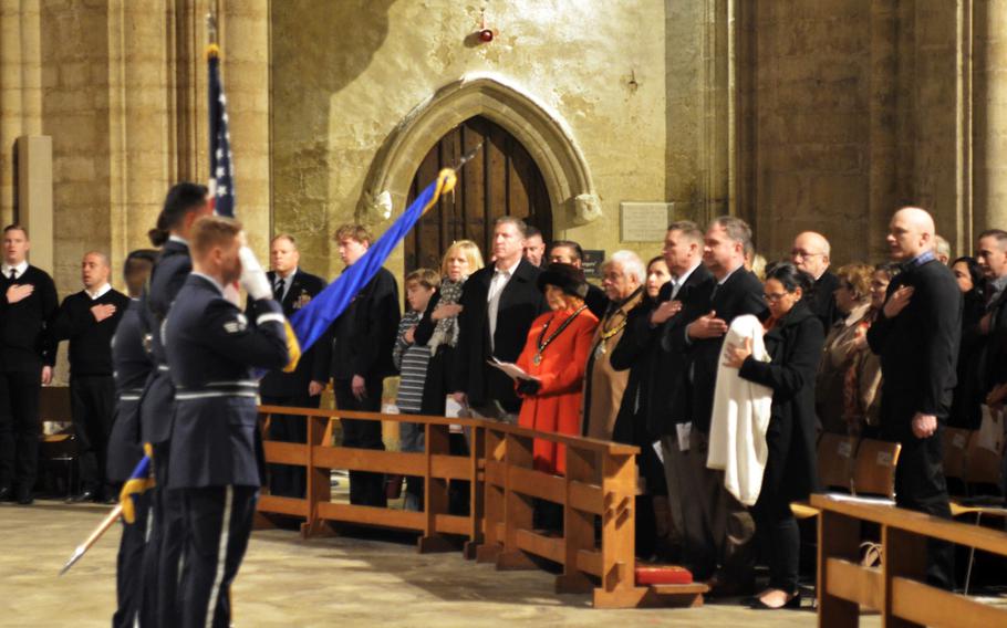 A U.S. Air Force honor guard stands before more than 1,000 U.S. servicemembers, families and British neighbors as the British and American anthems are played during a church service on the Eve of Thanksgiving Wednesday, Nov. 23, 2016, at the historic Ely Cathedral in England.