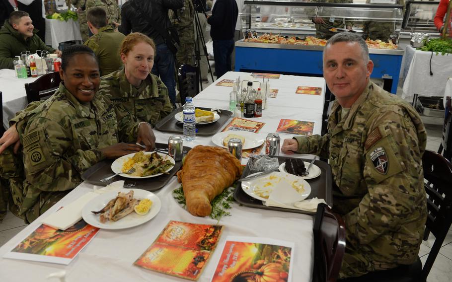 Army Col. Tammy Heath, left, Army Col. Kate Guttormsen, center, and Navy Capt. Bill Salvin, right, celebrate Thanksgiving at NATO's Resolute Support headquarters in Kabul, Afghanistan, on Thursday, Nov. 24, 2016.