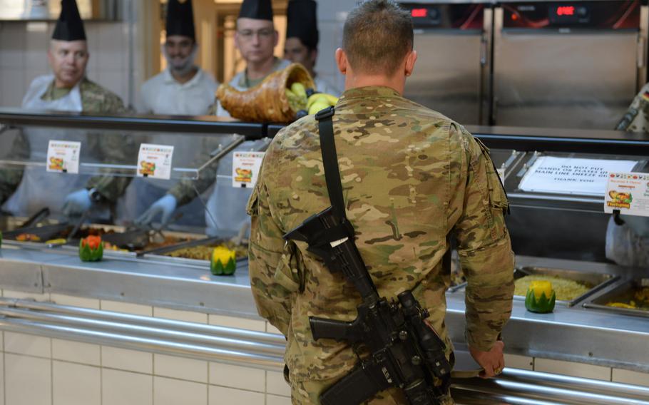 A servicemember gets his Thanksgiving meal at the dining hall at Resolute Support headquarters in Kabul, Afghanistan, on Thursday, Nov. 24, 2016.