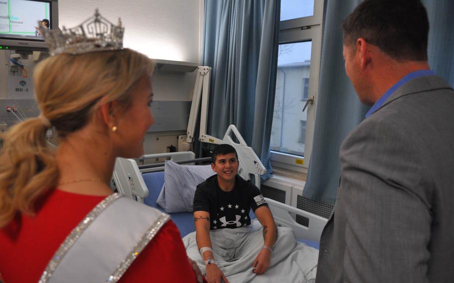 Savvy Shields, Miss America 2017, and Patrick Murphy, under secretary of the Army, visit with Army Cpl. Kayla Aninion at Landstuhl Regional Medical Center, Germany on Friday, Nov. 25, 2016. 