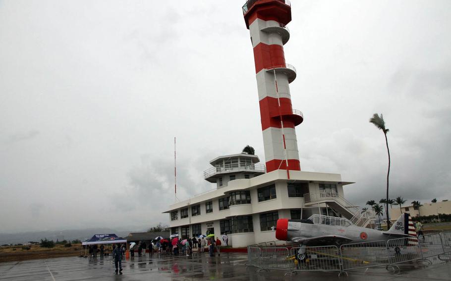 A restored aerological tower (the small, white structure) that served as a flight-control center during the 1941 surprise attack by the Japanese was dedicated Sunday by the Pacific Aviation Museum Pearl Harbor, Sunday, Dec. 4, 2016. The tall orange-and-white tower was still under construction during the attack.