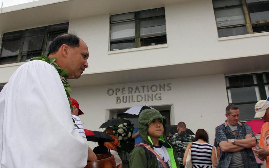 Kordell Kekoa performs a Hawaiian blessing for the newly restored aerological tower at the Pacific Aviation Museum on Ford Island, Hawaii, Sunday, Dec. 4, 2016. The tower was used to direct American aircraft in defense of the Japanese' surprise attack on Dec. 7, 1941.