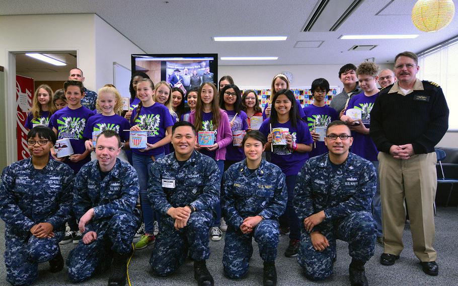 Sailors from the USS Shiloh and Yokosuka Middle School students pose for a photo after the completion of a Civil War history project Dec. 13, 2016.