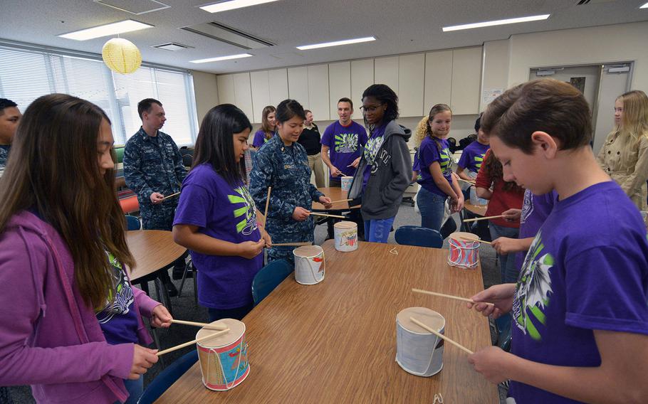 USS Shiloh sailors and Yokosuka Middle School students practice playing Civil War-style drums as part of a history project Dec. 13, 2016.