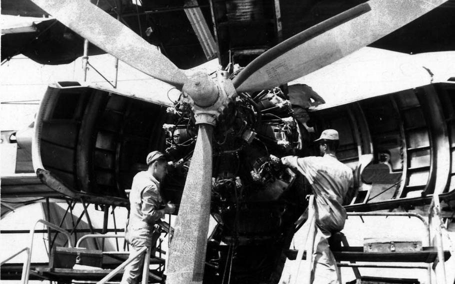 Nationalist Chinese technicians repair the engine of a U.S. Air Force C-123 at Tainan Air Base in 1966.