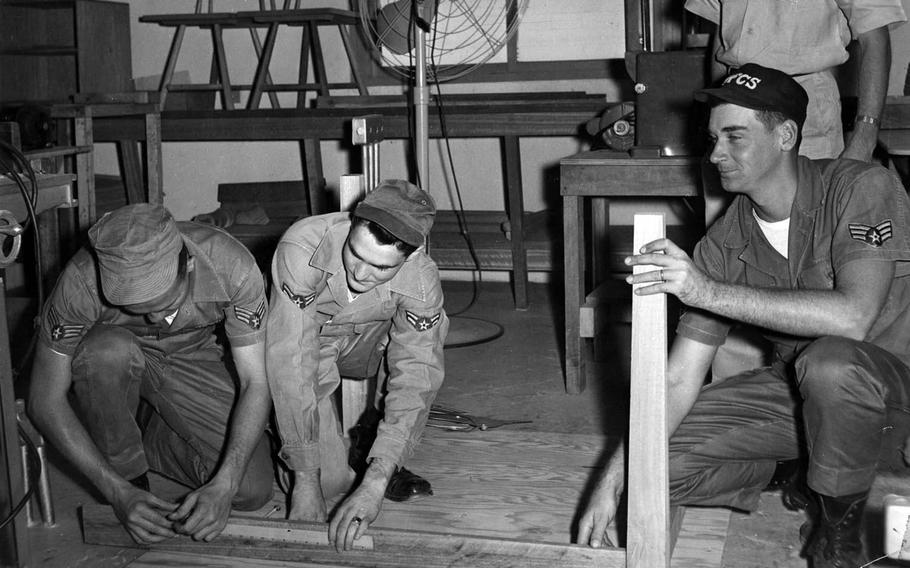 Airmen of the communications detachment build tables for the Tainan Special Skin Clinic in Taiwan in 1961.