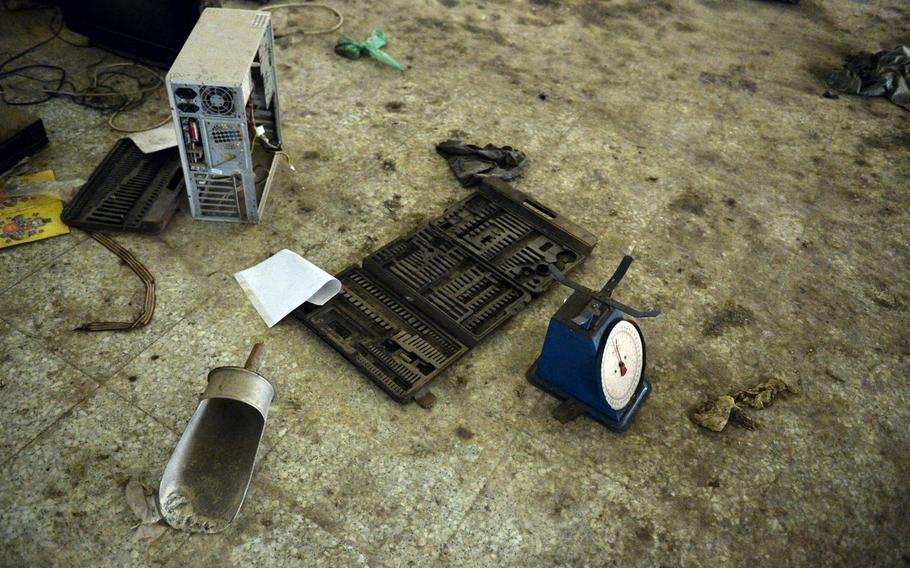 Several of the Islamic State group's bomb-making tools and materials — a computer tower stripped of its wiring and a large scoop and a scale — are pictured here on the floor of a building at St. George's Church in Qaraqosh, Iraq, where the militants had established a munitions factory, Dec. 17, 2016.