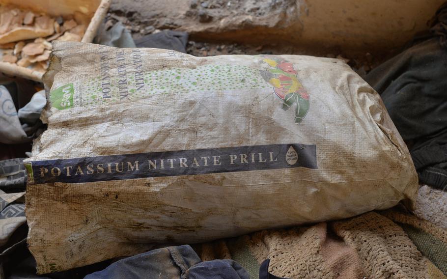 A bag of potassium nitrate, a precursor in producing rocket propellant, is pictured here among blankets in a building at St. George's Church in Qaraqosh, Iraq, Dec. 17, 2016. The church building was used to manufacture munitions.