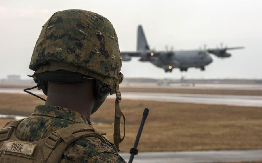 Marine Corps Staff Sgt. George Price directs a KC-130J Hercules during aircraft landing zone training at Marine Corps Air Station Iwakuni, Japan, in late December.