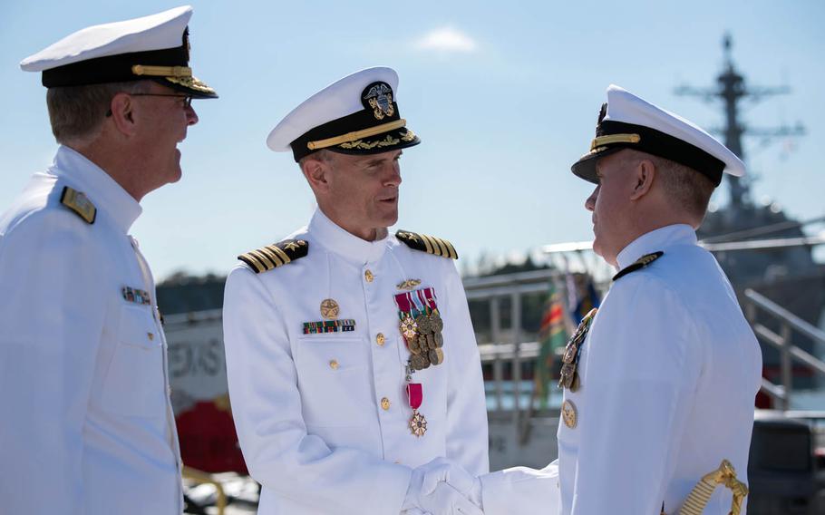 Capt. Timothy Rexrode, center, the outgoing commander of Submarine Squadron 1, greets Capt. Richard Seif, right, the incoming commander, at a change-of-command ceremony Thursday, Jan. 5, 2017, at Joint Base Pearl Harbor-Hickam, Hawaii. Rear Adm. Frederick "Fritz" Roegge, left, commander of U.S. Pacific Fleet's Submarine Force, praised Rexrode's leadership during the ceremony.
