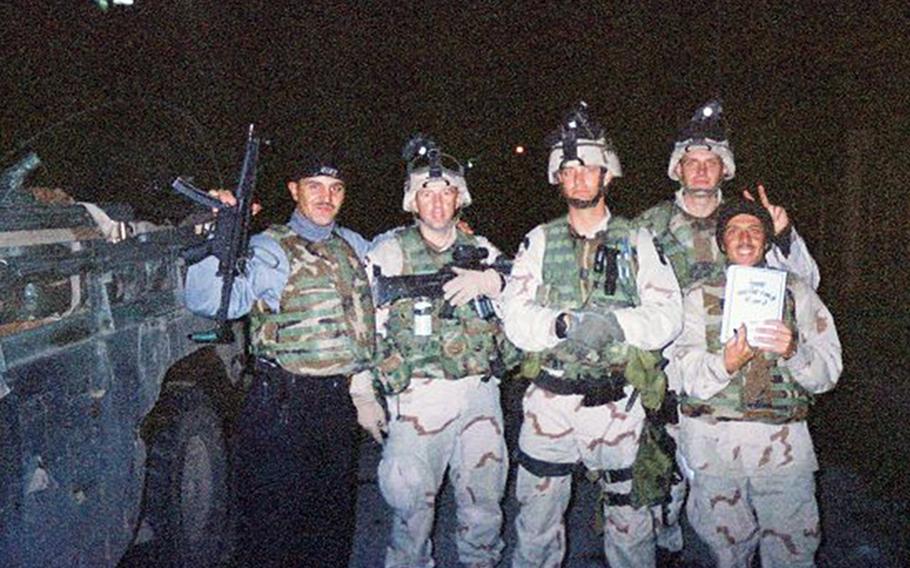 Soldiers with the 101st Airborne Division, including then-Sgt. 1st Class Eric Geressy (second from left) pose with an Iraqi police officer and interpreter in Mosul, Iraq 2003.