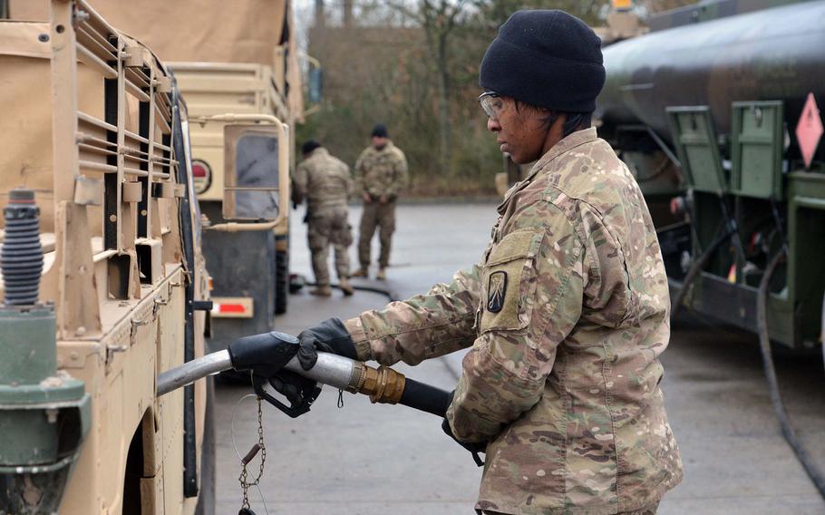 Staff Sgt. Priscella Gray of the Baumholder, Germany-based 515th Transportation Company fuels up a Humvee that had convoyed from Bremerhaven, Monday, Jan. 9, 2017. On the way to Poland, the convoy ended its first day at a training area near Belsen, Germany.