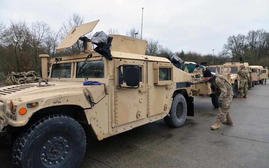 Military policemen check out their Humvees after arriving at a training area near Belsen, Germany, on their way to Poland from Bremerhaven, Germany, Monday, Jan. 9, 2017.