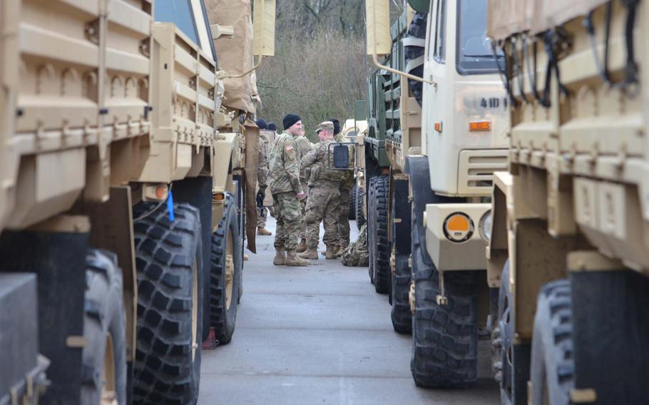 Soldiers talk after arriving at a training area near Bergen, Germany, after convoying from Bremerhaven on their way to Poland as part of Operation Atlantic Resolve, Monday, Jan. 9, 2017.