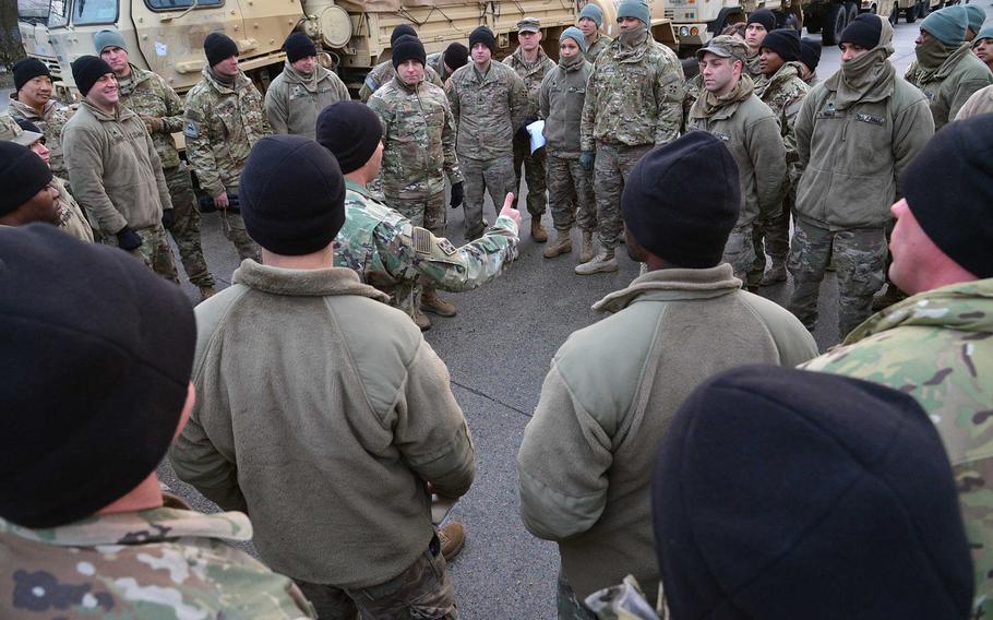 Soldiers of 3rd Armored Brigade Combat Team, 4th Infantry Division have a mission briefing before heading out on the second day of a convoy to Poland on Tuesday, Jan. 10, 2017.
