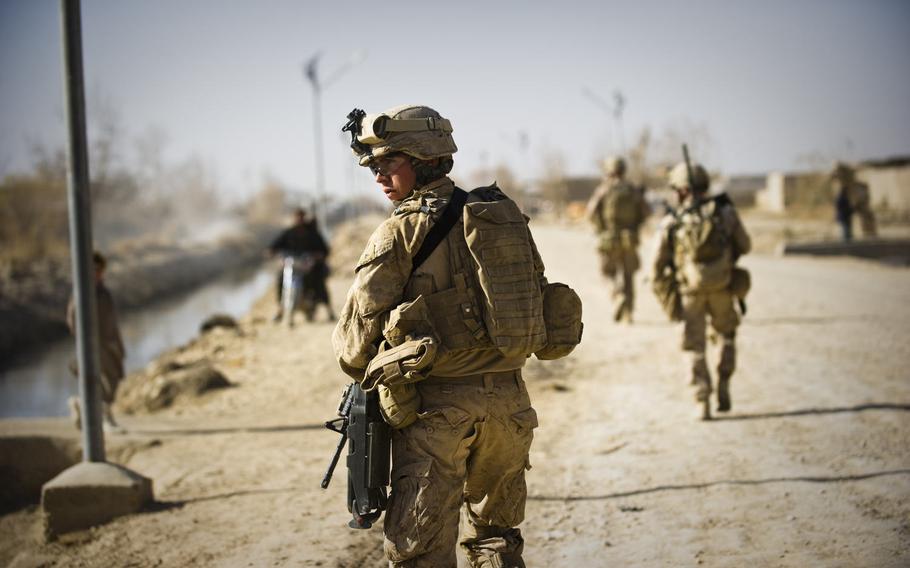 Marines assigned to 3rd Battalion, 9th Marines, patrol the streets of Marjah, Afghanistan, Dec. 17, 2010.