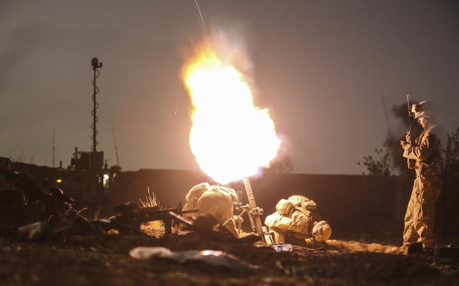 U.S. Marines with Charlie Company, 1st Battalion, 2d Marine Regiment, launch illumination rounds from a 61 mm mortar system during a night security patrol in Helmand province, Afghanistan, Sept. 11, 2014.
