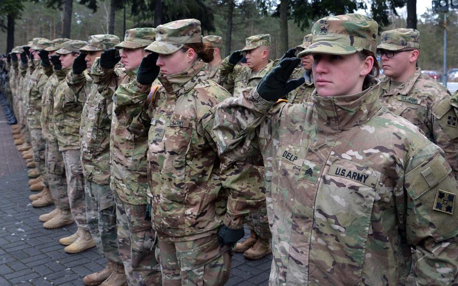 American soldiers of 3rd Armored Brigade Combat  Team, 4th Infantry Division, salute during the playing of the national anthem during a welcoming ceremony for them in Zagan, Poland, Thursday, Jan. 12, 2017.