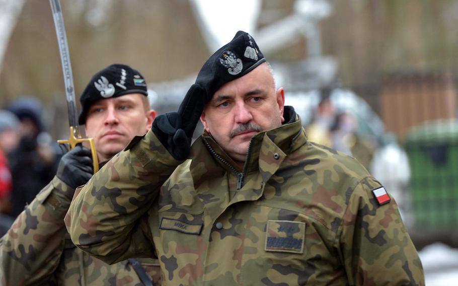 Polish Maj. Gen. Jaroslaw Mika, commander, 11th Armoured Cavalry Division, salutes American troops of the 3rd Armored Brigade Combat Team, 4th
Infantry Division, during a welcoming ceremony for the Americans in Zagan, Poland, Thursday, Jan. 12, 2017.