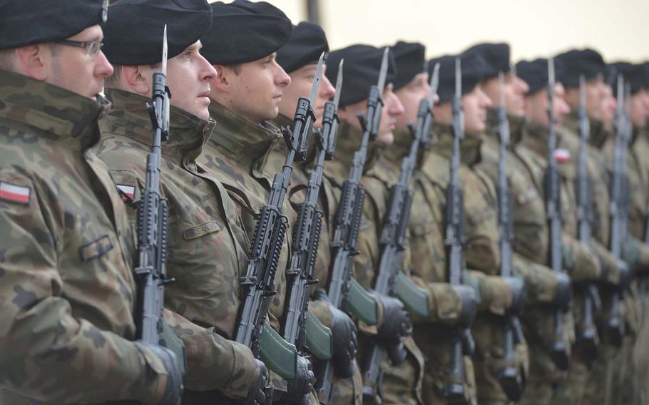 Polish soldiers stand at attention during a welcoming ceremony for the 3rd Armored Brigade Combat Team, 4th Infantry Division, in Zagan, Poland, Thursday, Jan. 12, 2017. The unit is on a nine-month deployment to eastern Europe as part of Operation Atlantic Resolve.