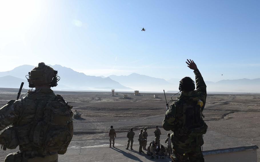 A student in a training program for Afghan Tactical Air Coordinators waves at an MD-530 attack helicopter during a live-fire exercise at a range south of Kabul, on Dec. 27, 2016.