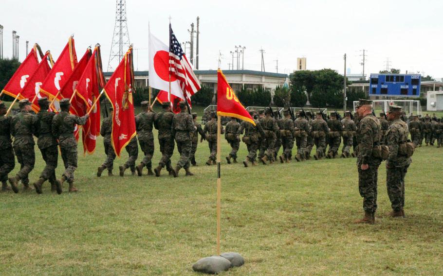 Marines from the nation's only forward-deployed Marine division march past in salute of their outgoing and incoming commanders during a change-of-command ceremony at Camp Courtney, Okinawa, Friday, Jan. 20, 2017. Maj. Gen. Richard Simcock II passed command of the 3rd Marine Division to Maj. Gen. Craig Timberlake.