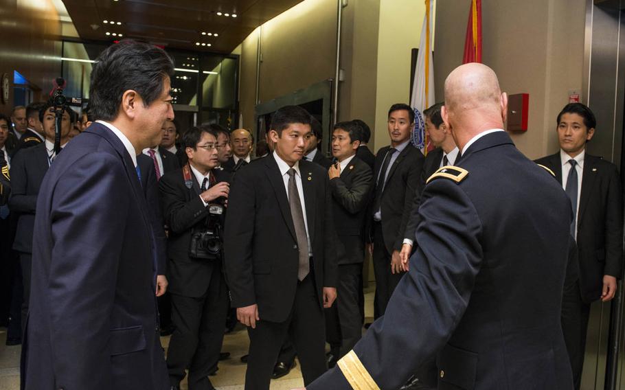 Japanese Prime Minister Shinzo Abe, left, tours the Defense POW/MIA Accounting Agency in Hawaii.