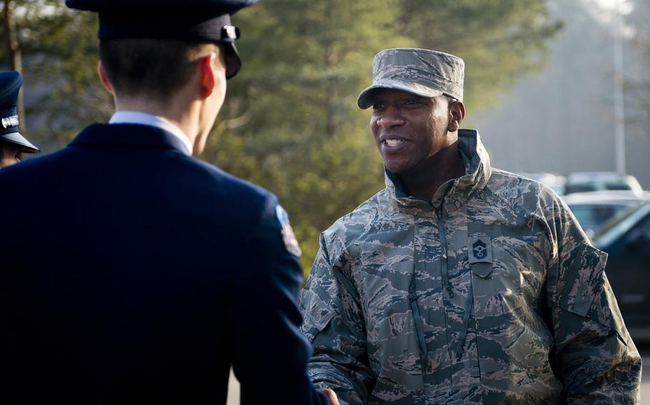 Chief Master Sgt. Kaleth Wright, U.S. Air Forces in Europe and Africa command chief master sergeant, shakes hands with an Air Force Junior Reserve Officer Training cadet at Ramstein Air Base, Germany, on Monday, Jan. 23, 2017.