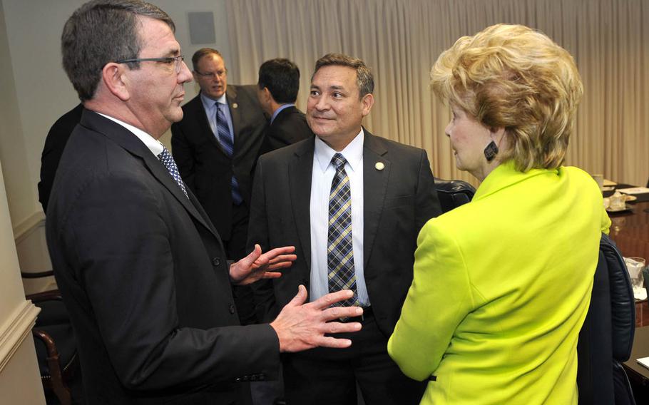 Then-Deputy Secretary of Defense Ash Carter, left, meets with Guam Gov. Eddie Calvo and Delegate Madeleine Z. Bordallo at the Pentagon in 2013. Calvo has ordered the Guam EPA to test the island for traces of Agent Orange.
