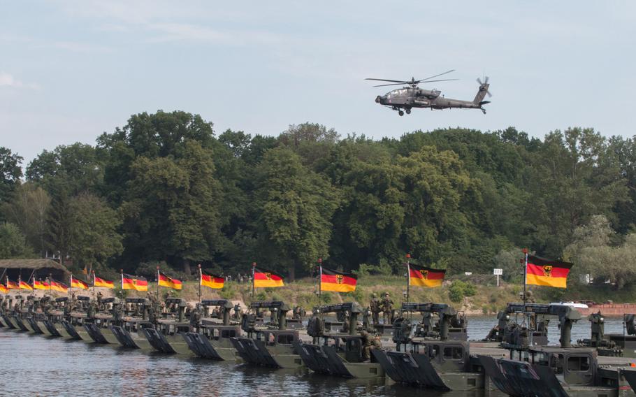 An AH-64 Apache helicopter soars over a newly constructed bridge over the Vistula River near Torun, Poland, in June 2016. Like many NATO countries, Germany has found it difficult to attain the alliance's defense budget goal of 2 percent of GDP.