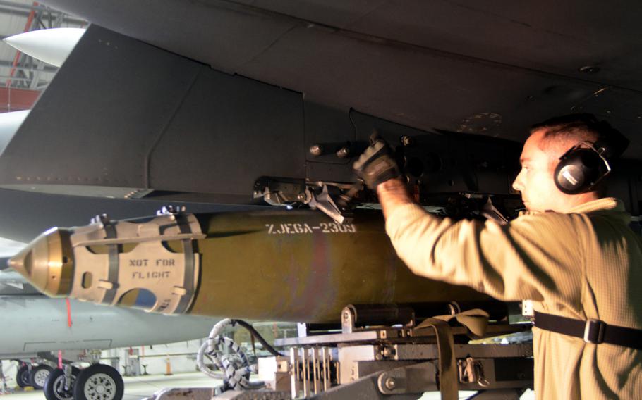 A weapons load crew team member from the 48th Maintenance Group loads ammunition onto an F-15C Eagle during the annual weapons load crew competition at RAF Lakenheath, England, Wednesday, Jan. 25, 2017.